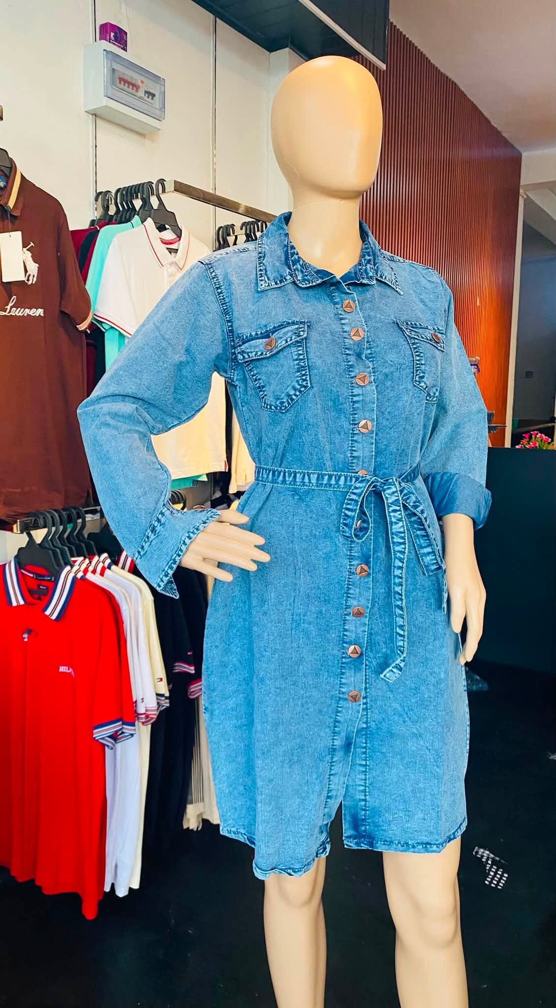 Blue button-front denim frock with a tie waist displayed on a mannequin